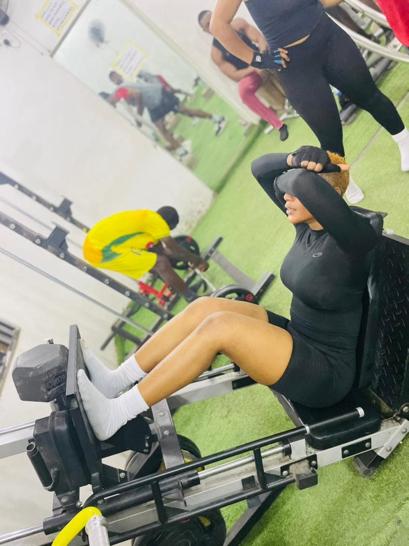 Two athletes posing together in the gym mirror